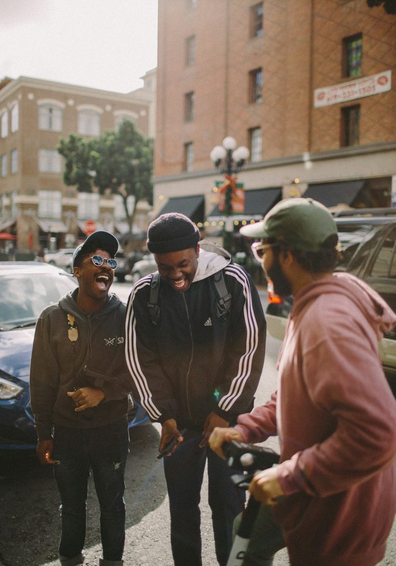 three men in jacket laughing at each other